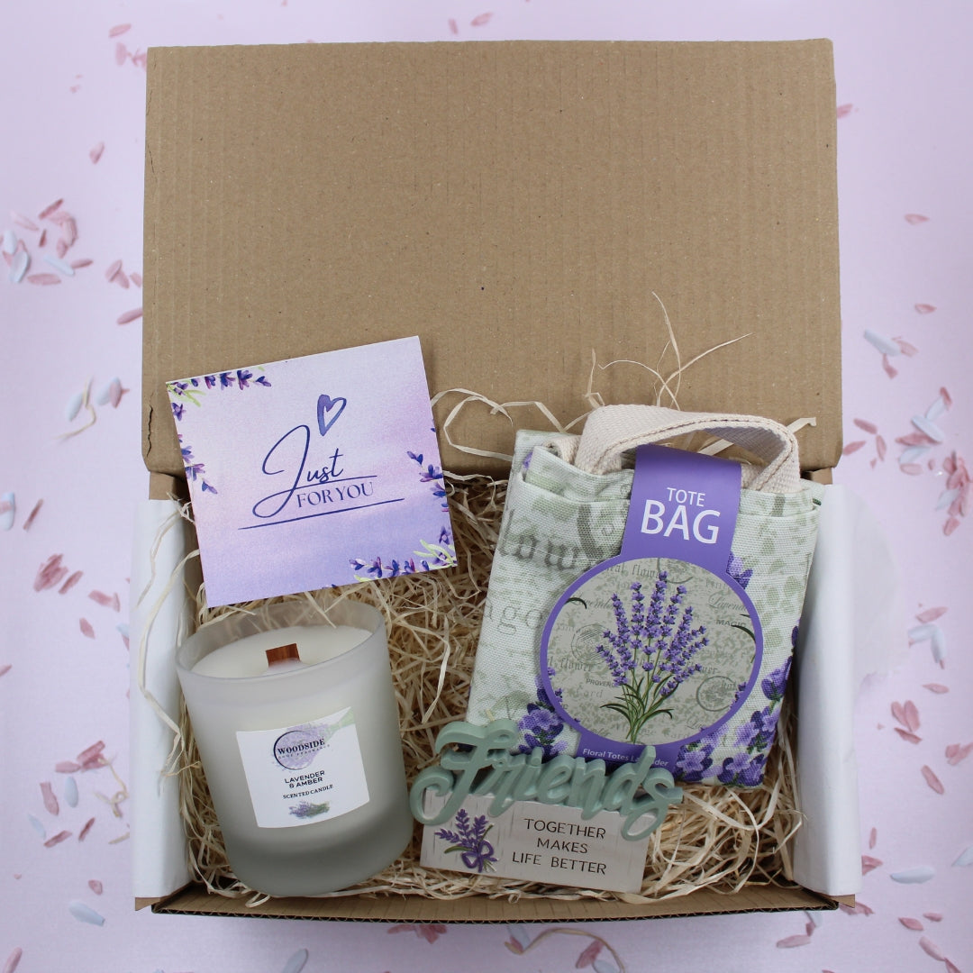 Gift set with candle, card, and tote bag on a pink background by Treat Box Shop