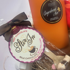 Holiday gingerbread gift set with candle, mug, socks, and sweet snacks