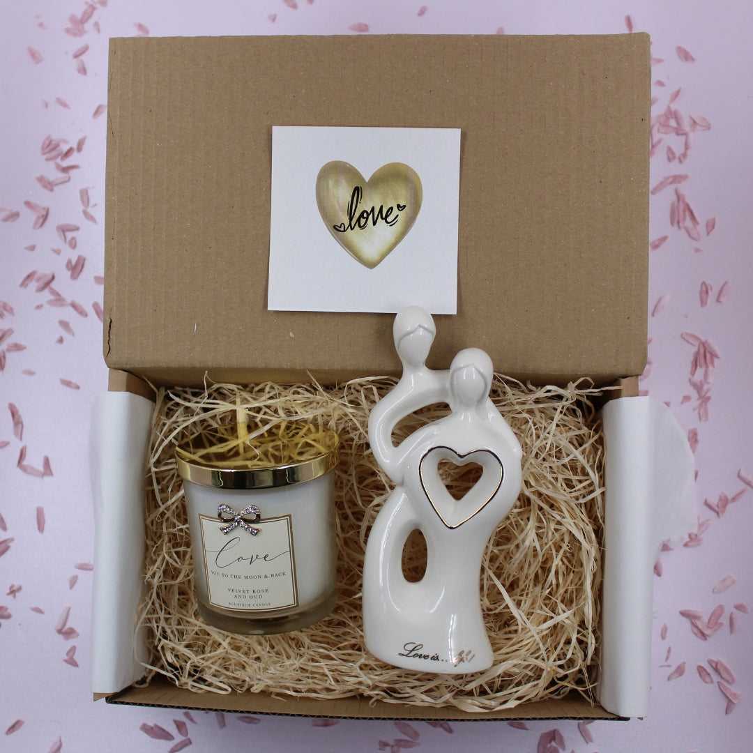Luxury white and gold anniversary gift box with candle and figurine